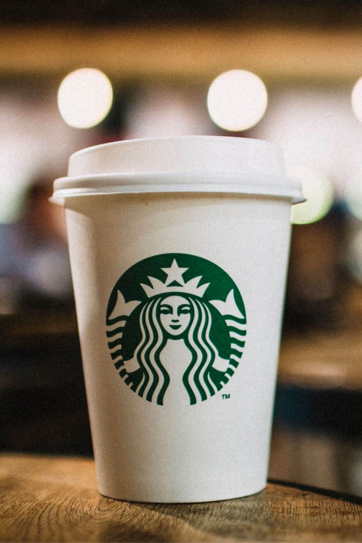 a cup of Starbucks coffee on a table.