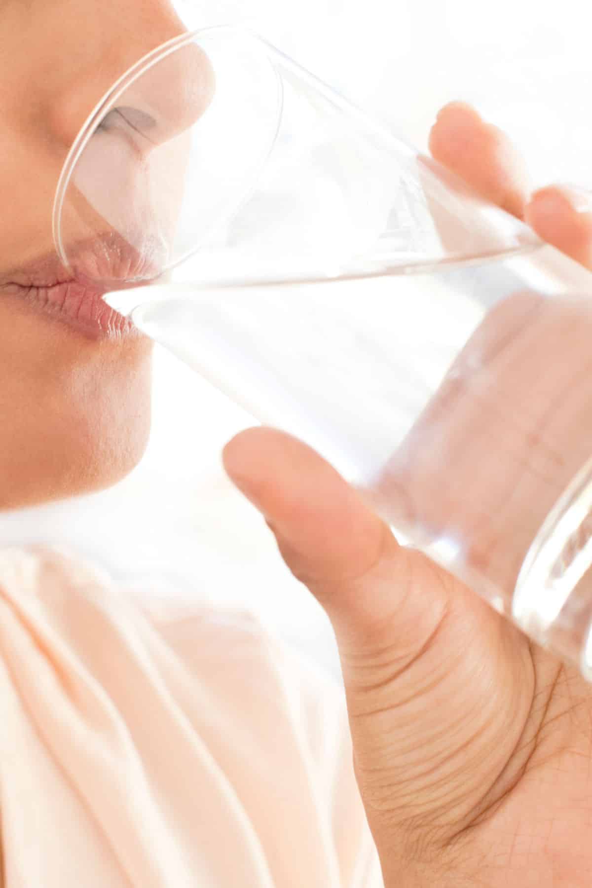 a woman drinking from a glass.