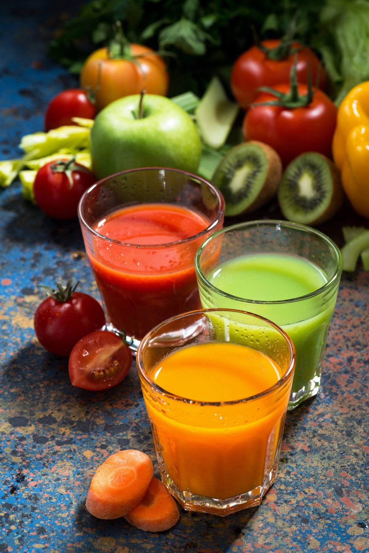 collection of colorful fruit and vegetables juices on table.
