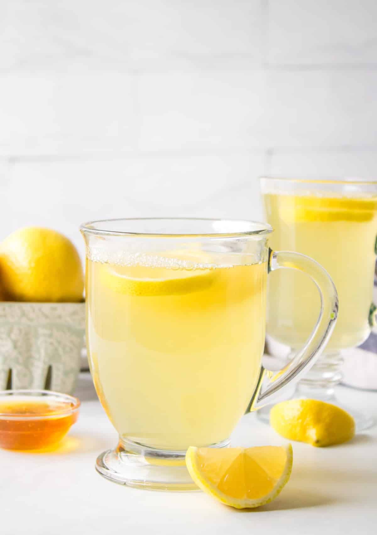 honey lemon tea served in clear mug with handle.