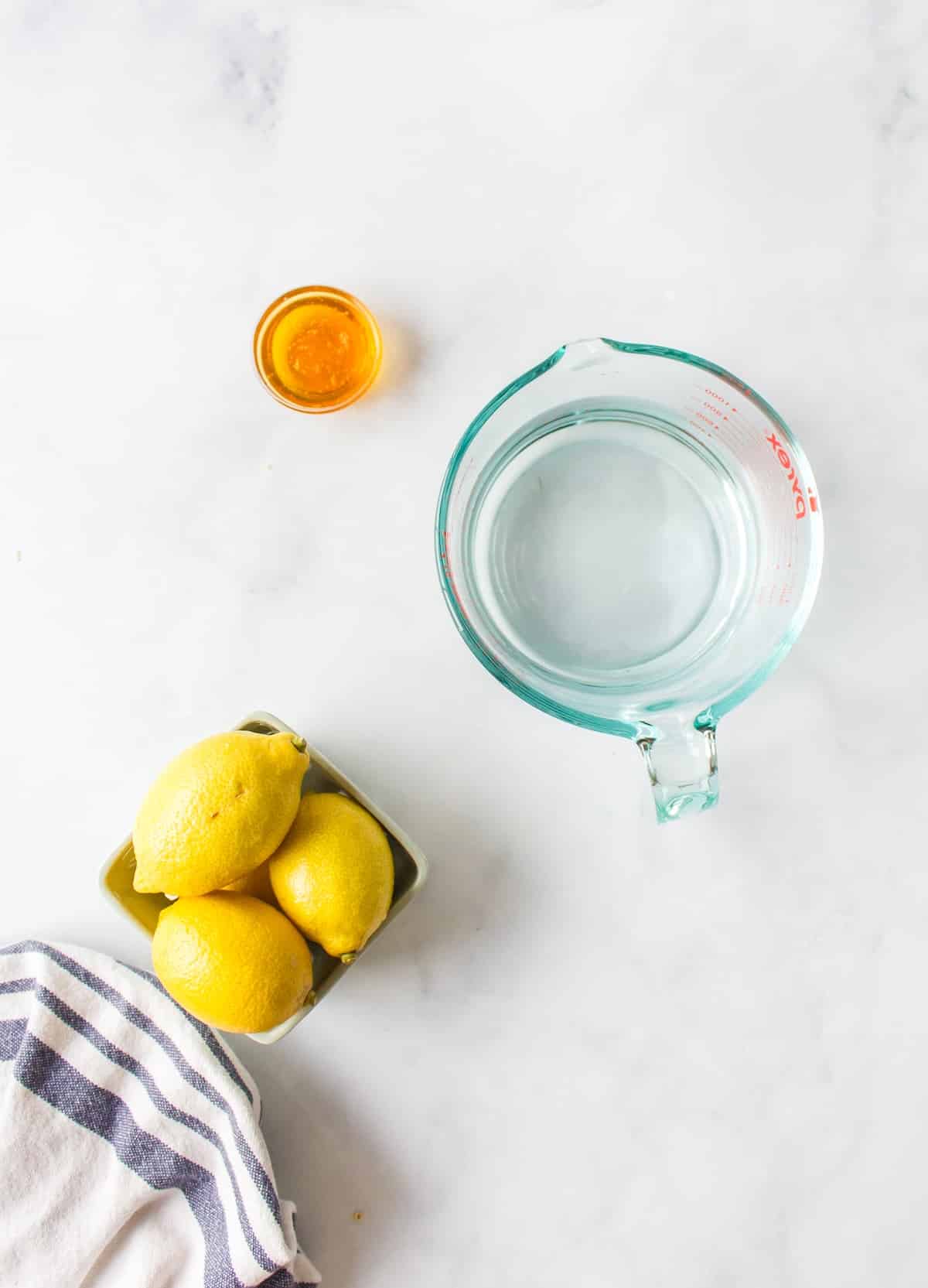 ingredients for honey lemon tea on countertop.