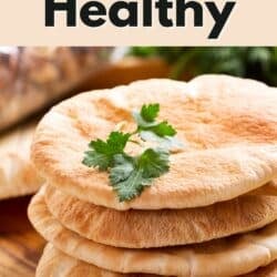 a stack of four pieces of pita bread on a wooden surface.