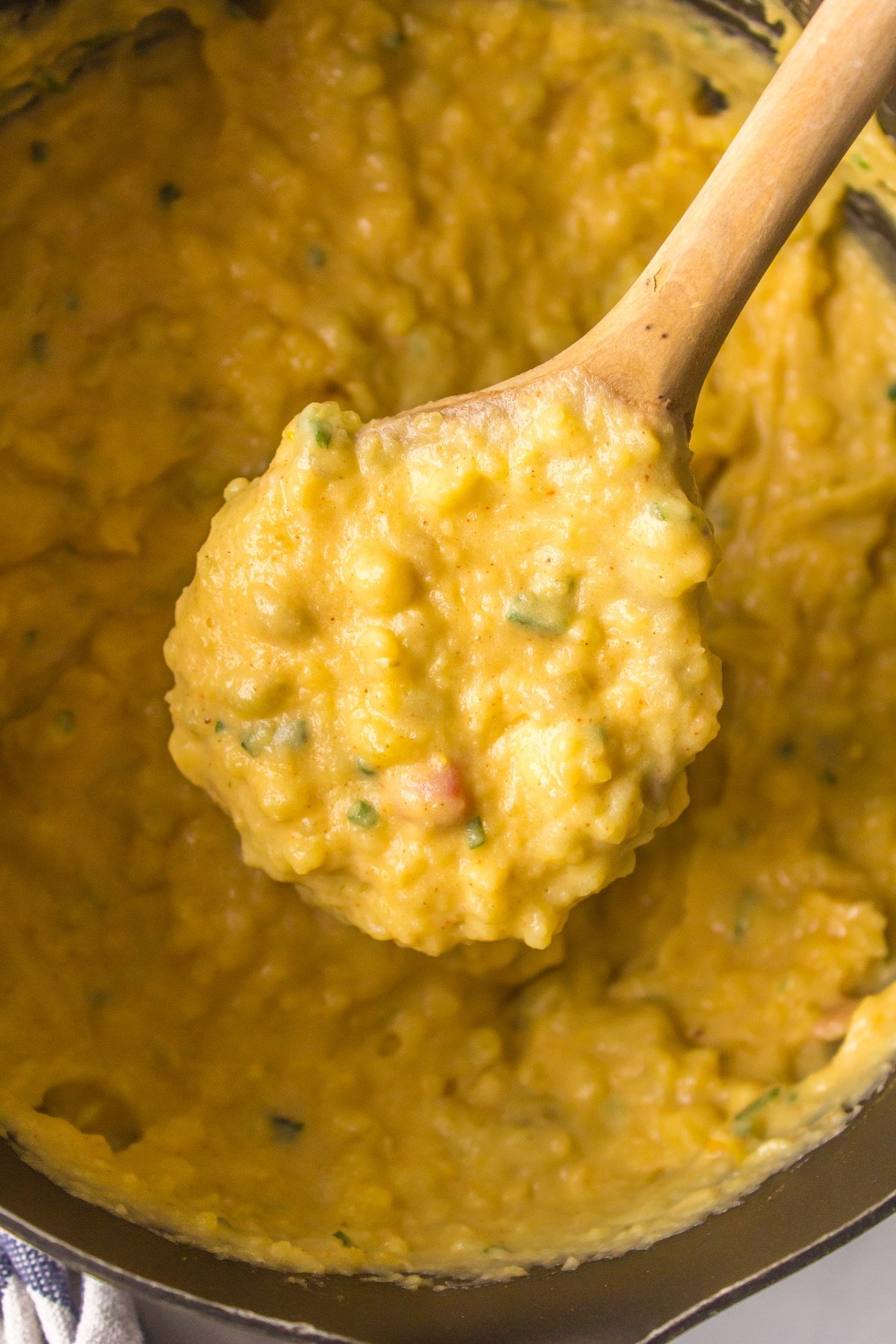a wooden spoon full of Mexican mashed potatoes.