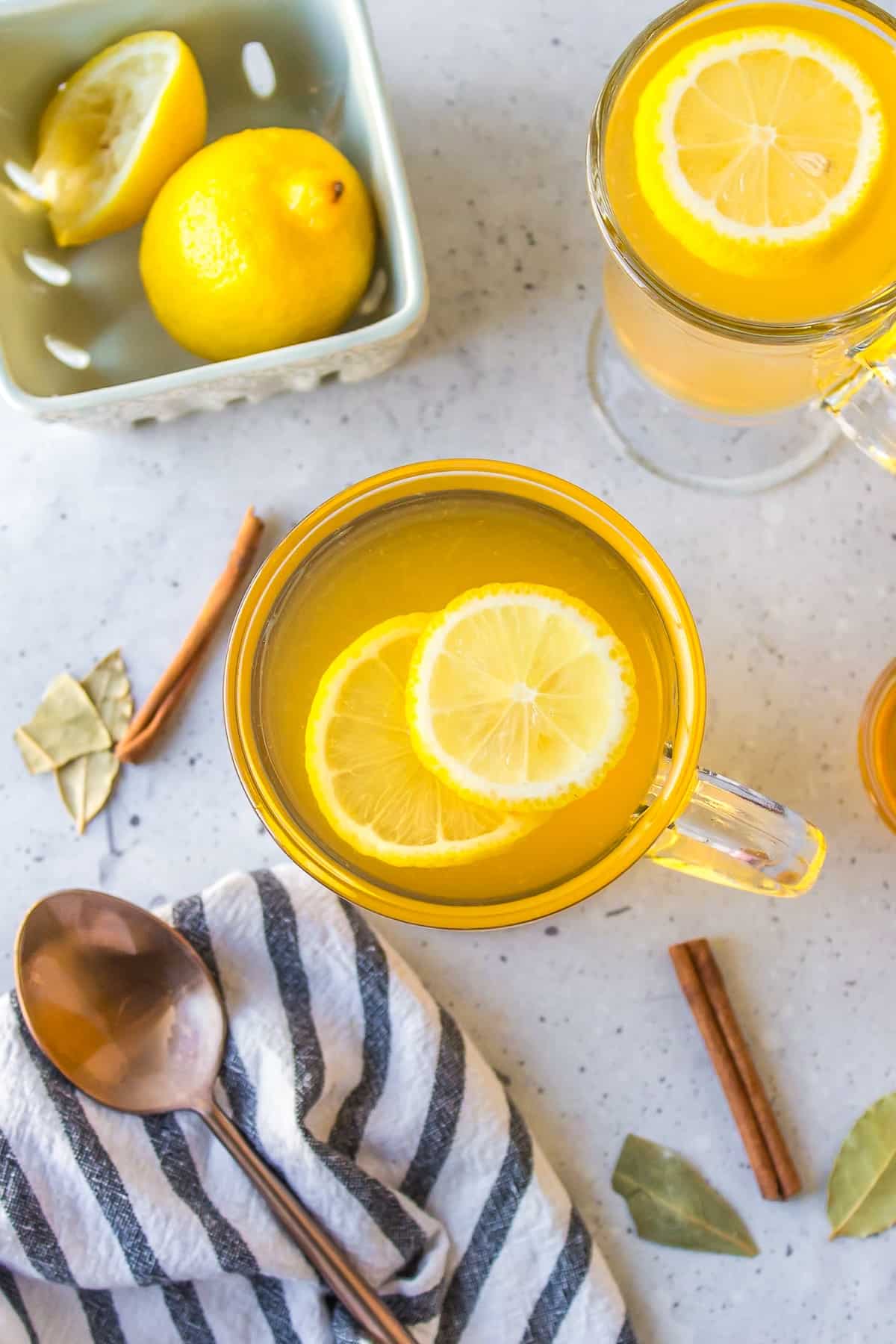 overhead shot of a glass of cinnamon and bay leaf tea.