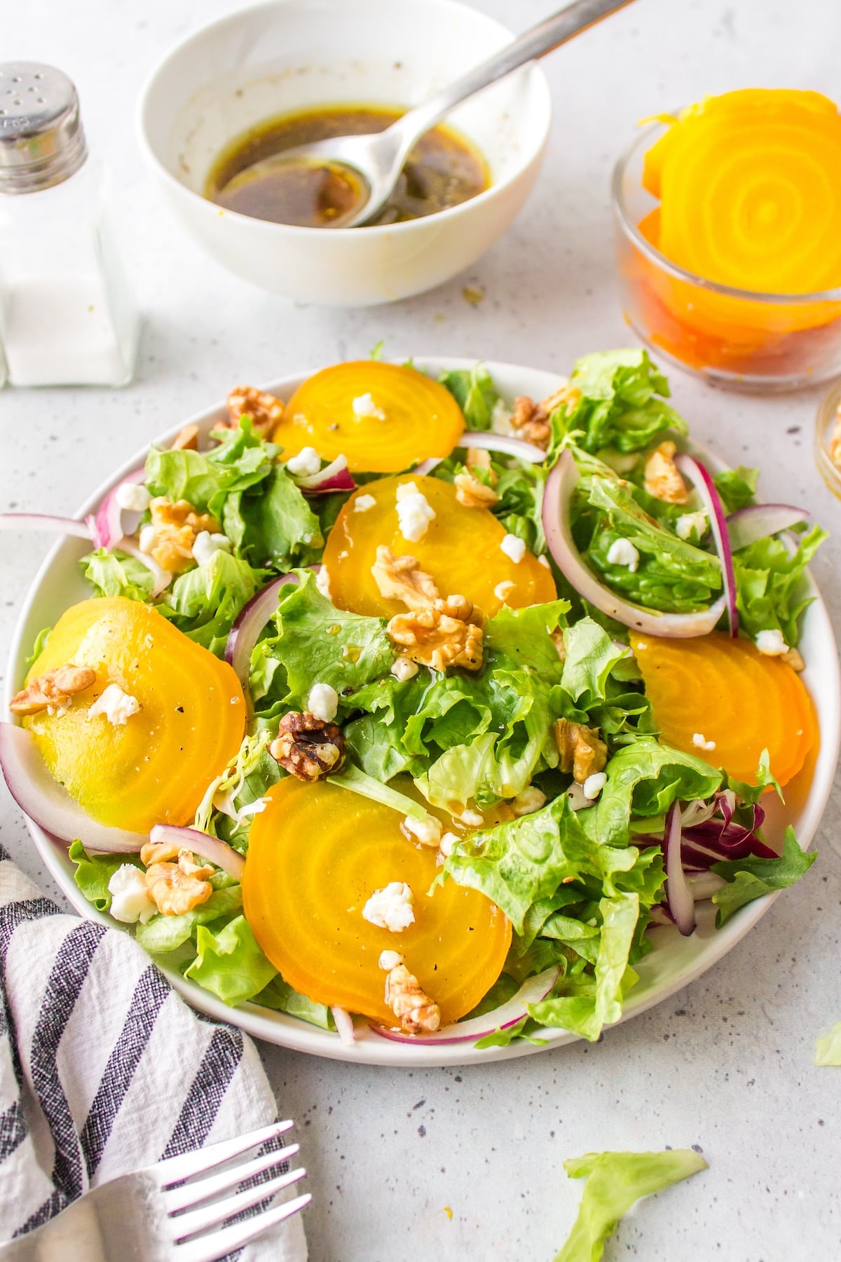 a white plate full of golden beet salad.