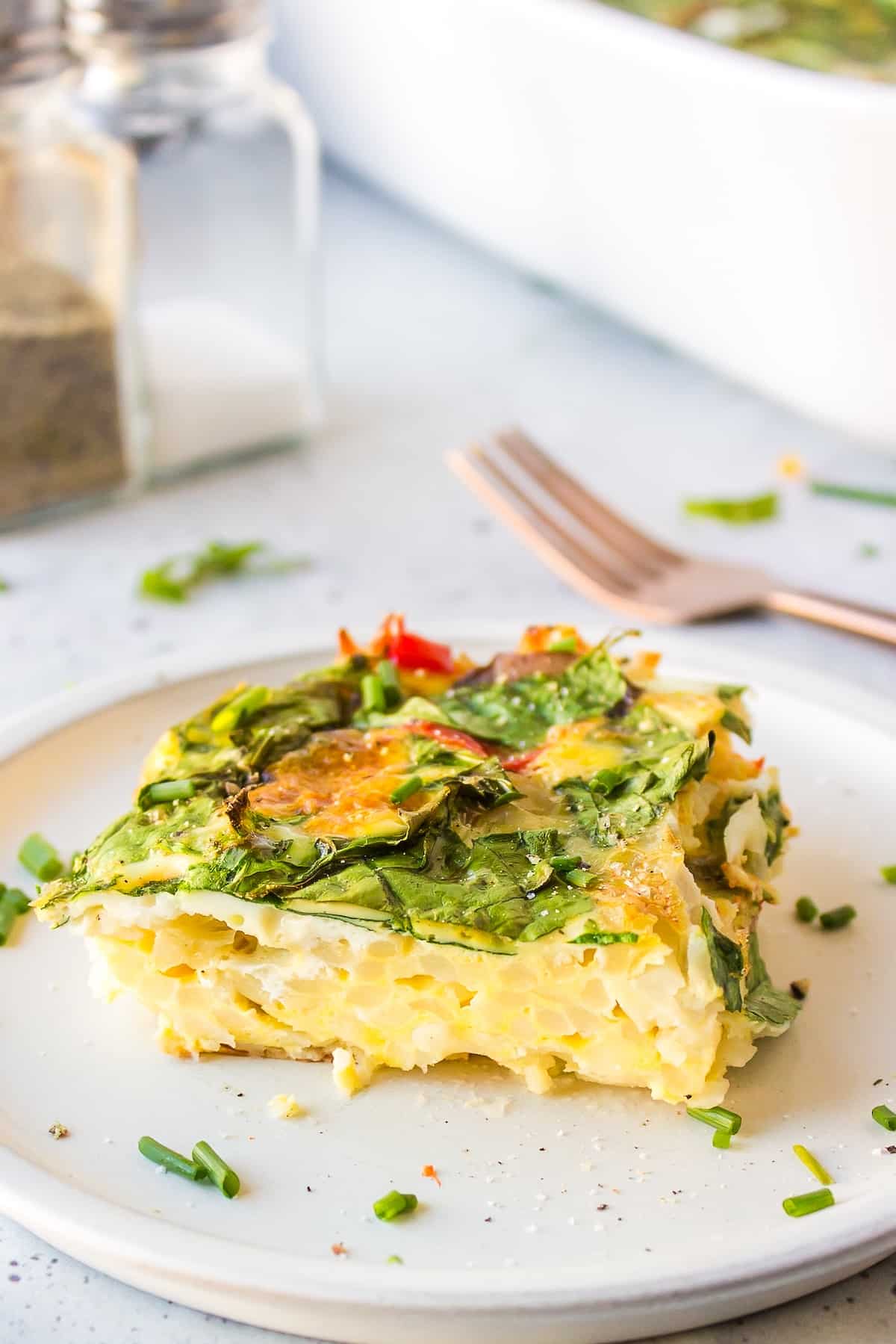 a slice of dairy-free breakfast casserole on white plate.