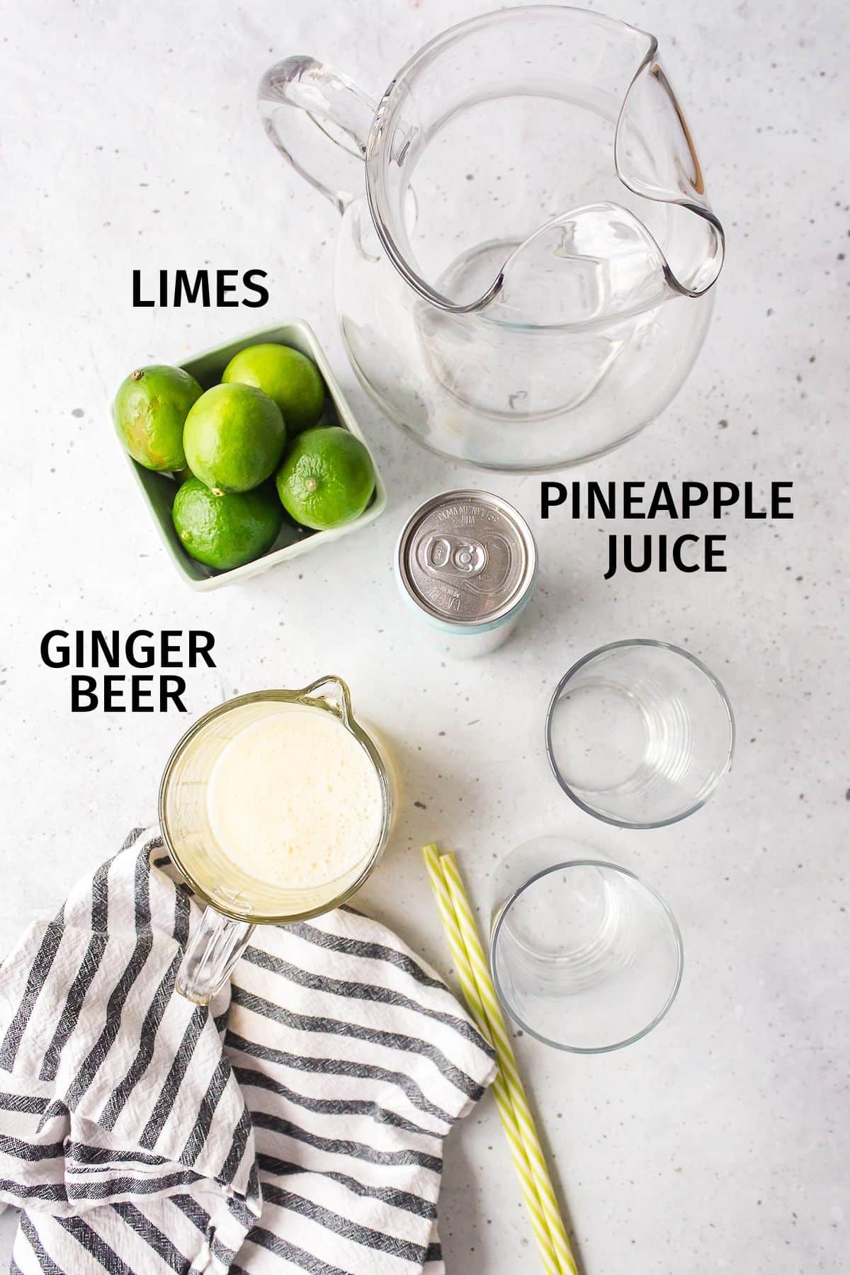 ingredients for a ginger beer mocktail on a white counter.