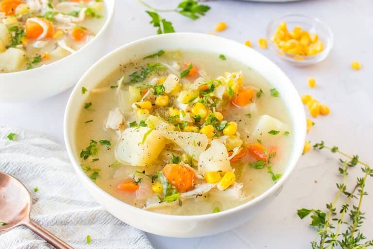 a bowl of crockpot chicken, corn and potato soup.