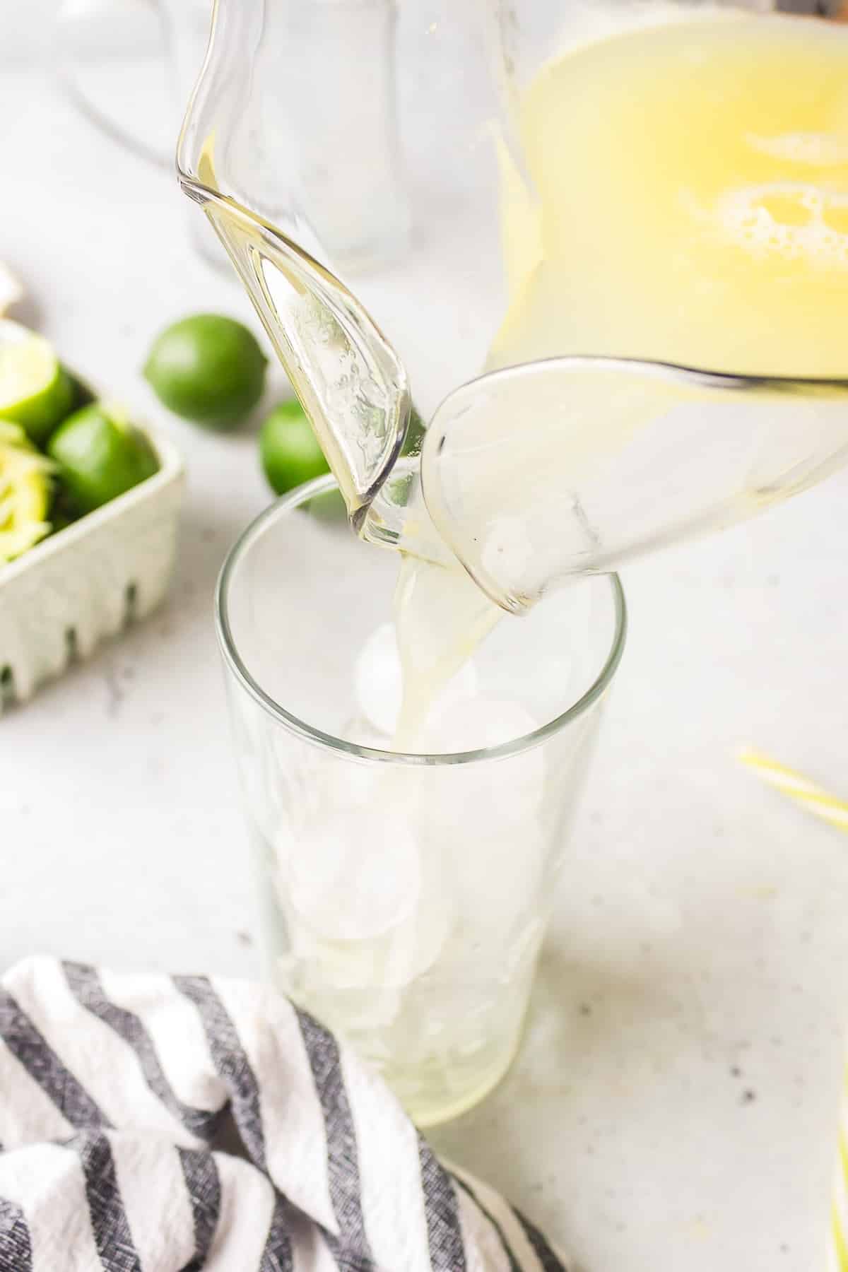ginger beer mocktail being poured over ice in a glass.