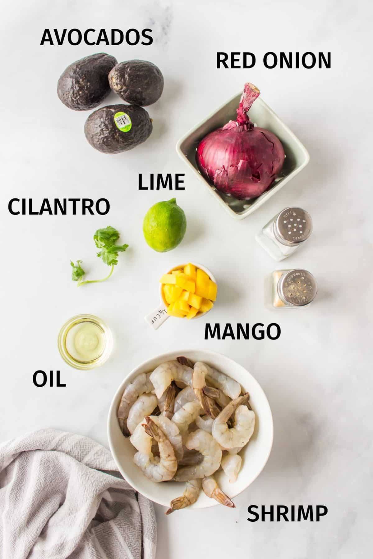 ingredients needed for avocado mango shrimp salad on a counter.