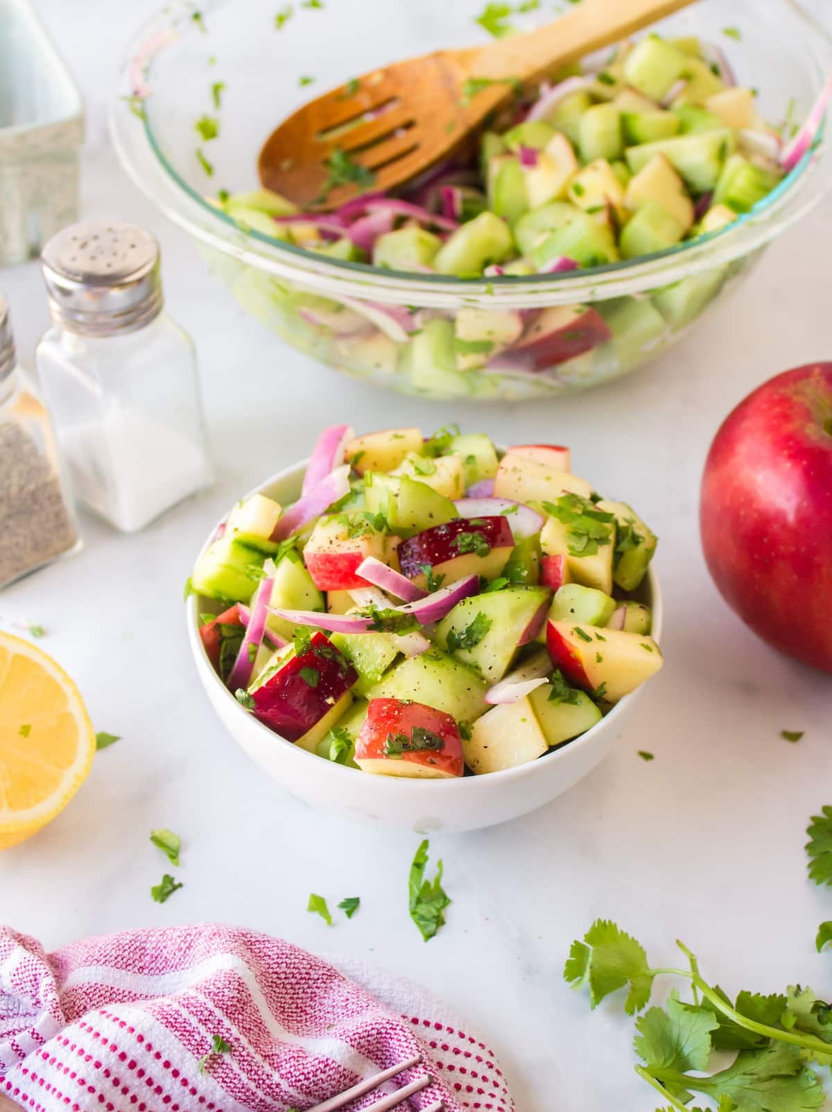 cucumber apple salad with serving bowl.
