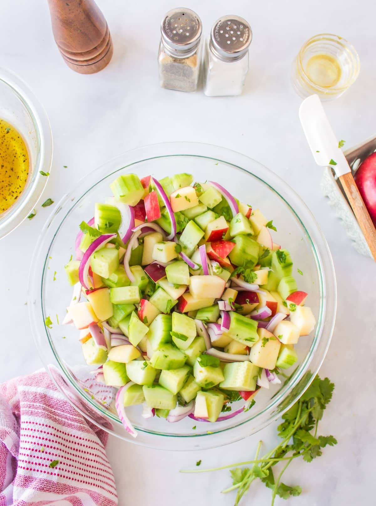 salad ingredients in bowl tossed with salad dressing.